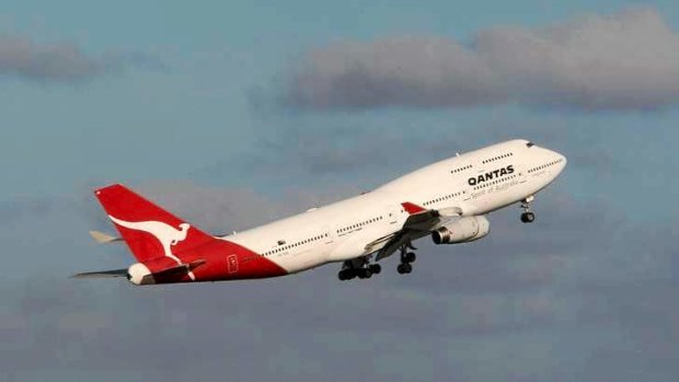 Qantas has cut its surcharges for customers buying tickets using a credit or debit card.
