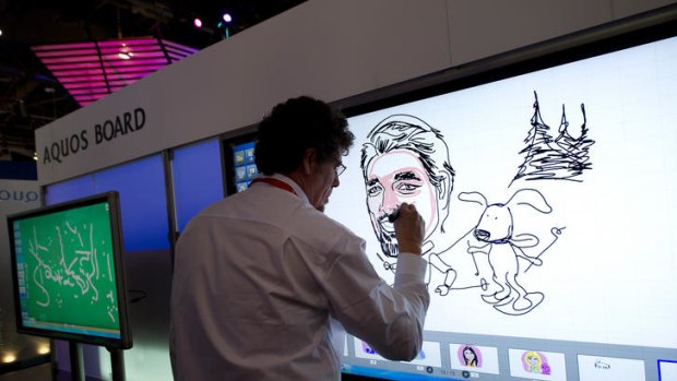 Ed Giorgano, artist with Sharp Electronics, draws a portrait of Jeff Albregts on a new Aquos Board Television at CES.