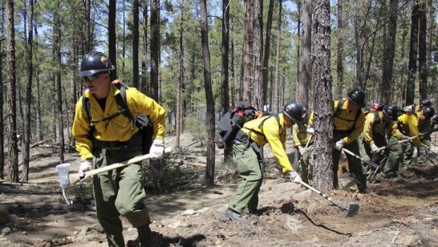 Members of the Granite Mountain Hotshots practice cutting fire lines in Prescott, Arizona, in this handout photo taken April 4, 2012.