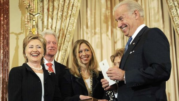 US Vice President Joe Biden swears in Hillary Clinton as US Secretary of State in 2009. In the background are former US President Bill Clinton and daughter Chelsea.