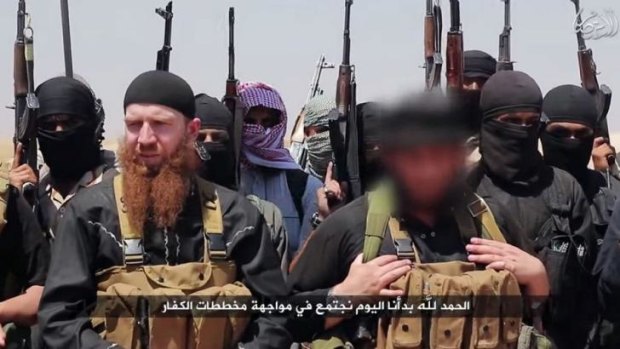 An image allegedly shows members of Islamic State, including Abu Omar al-Shishani (left) and ISIL sheikh Abu Mohammed al-Adnani (right), whose picture was blurred from the source to protect his identity, at an unknown location in Iraq or Syria.