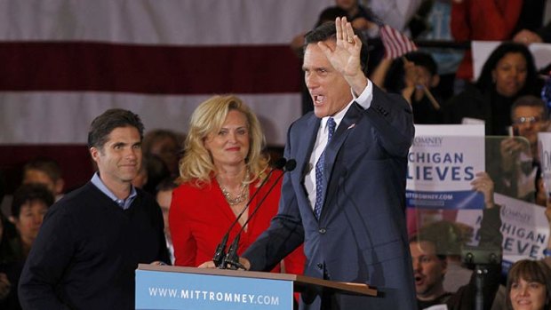 Wins for Romney ... the former Massachusetts waves to the crowd as his wife, Ann, and son, Tag, look on.
