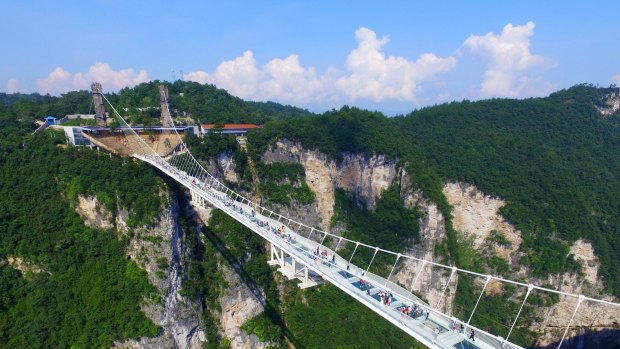 The bridge, which opened to the public on a trial basis on Saturday, spans 430 metres and rises about 300 metres above a valley.