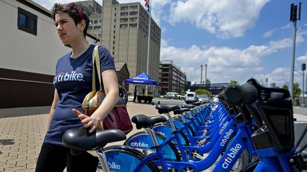 Dani Simons, director of marketing and external affairs with NYC Bike Share explains the process of using the bicycles at a dock and lock station at the Brooklyn Navy Yards.