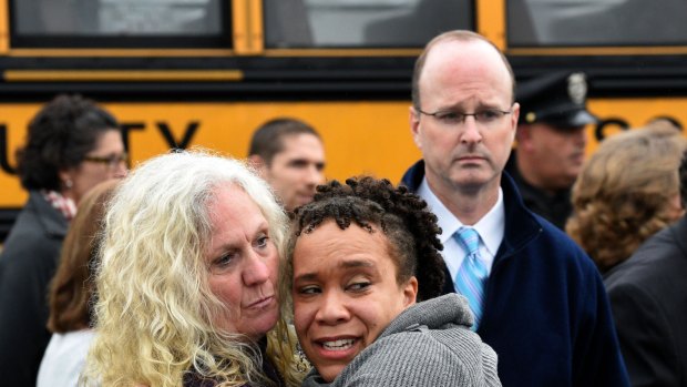 Clovis Stair, left, supervisor of Knox County School psychology, consoles Sunnyview Primary School Principal Sydney Upton near the scene where two school buses crashed in Knoxville.