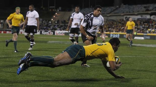 Over ... Kurtley Beale scores his first Test try against Fiji on Saturday night.