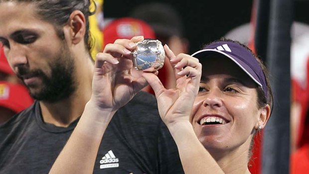 Anabel Medina Garrigues of Spain studies the diamond encrusted silver tennis ball she won with partner Fernando Verdasco after defeating Ana Ivanovic and Novak Djokovic of Serbia in the mixed doubles.