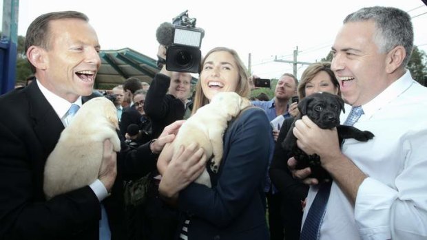 Reaping the rewards of a successful campaign: Tony Abbott with daughter Frances and Joe Hockey.