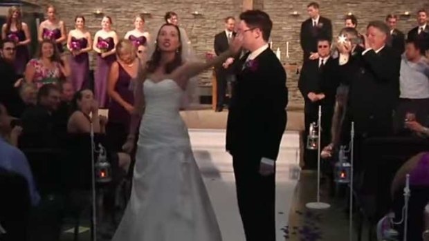 A couple dances down the aisle to Journey's Don't Stop Believin'.