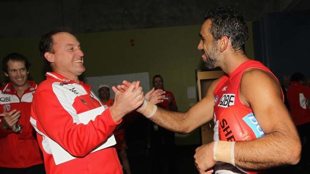"We have got off to a good start. I said it before the game and I will say it again - it is a good start and that is all it is" ... John Longmire, left,  congratulates Adam Goodes.