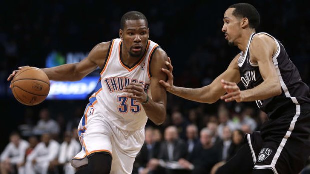 Oklahoma City Thunder's Kevin Durant moves around Brooklyn Nets opponent Shaun Livingston.