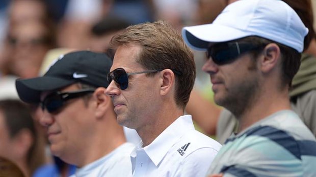 Former champion Stefan Edberg of Sweden (centre) looks on as his ward cruises to victory.