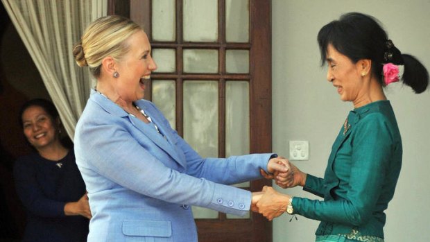 Hillary Clinton is greeted by Aung San Suu Kyi at her residence in Rangoon. The Burmese pro-democracy leader called for the release of 2000 political prisoners.