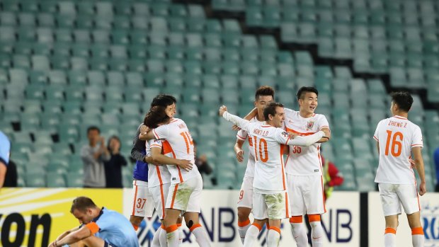 Blue ending: Shandong Luneng players celebrate at full-time on Wednesday night.
