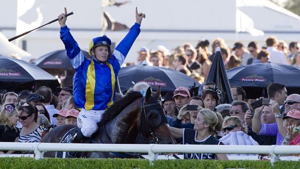 Special horse: James McDonald salutes the crowd after winning on It's A Dundeel.