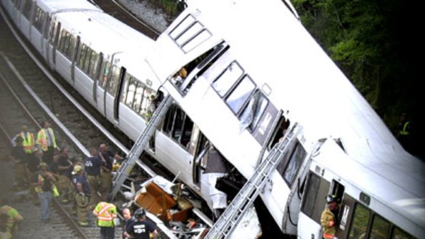 Train smash ... Emergency personnel work to free trapped passengers.