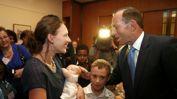 Prime Minister Tony Abbott meets Anna Dombkins and her 8-week-old baby Max Dombkins during a morning tea ahead of Adoption Awareness Week in November.
