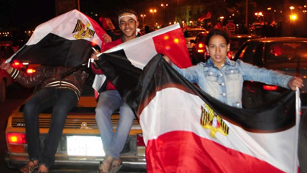 Protesters celebrate Mubarak's resignation in the Egyptian city of Alexandria.