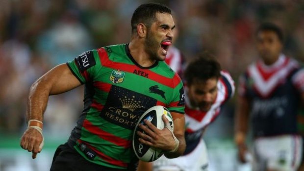 Monster start: Greg Inglis on his way to a hat trick in round one against the Roosters.