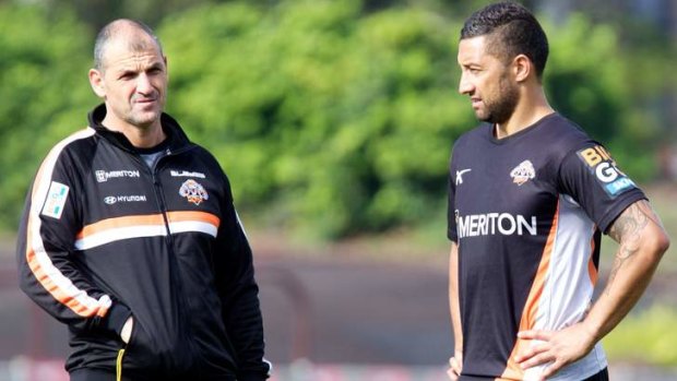 Mind is elsewhere: Benji Marshall with Tigers assistant coach Steve Georgallis at training on Tuesday.