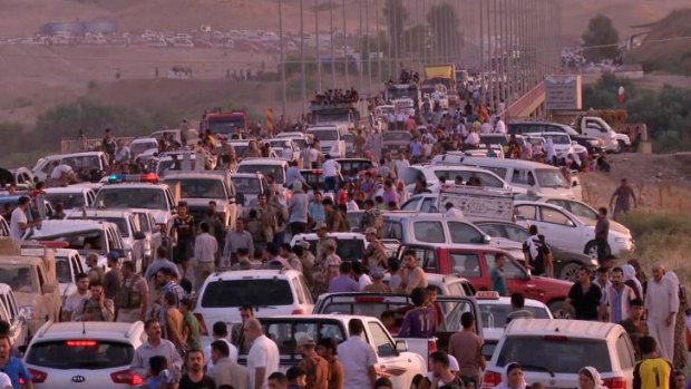 Iraqis from the Yazidi minority flee in a convoy to Erbil, the capital of Iraq's Kurdish autonomous region.