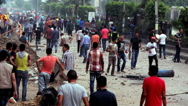 Protesters and Mursi supporters clash outside Cairo University on Wednesday.