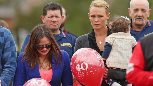 Tribute: Chris Lane's girlfriend Sarah Harper, pictured with Chris's sister Erin and holding his niece  Amelia, came out from the US for Sunday's memorial game on Sunday.