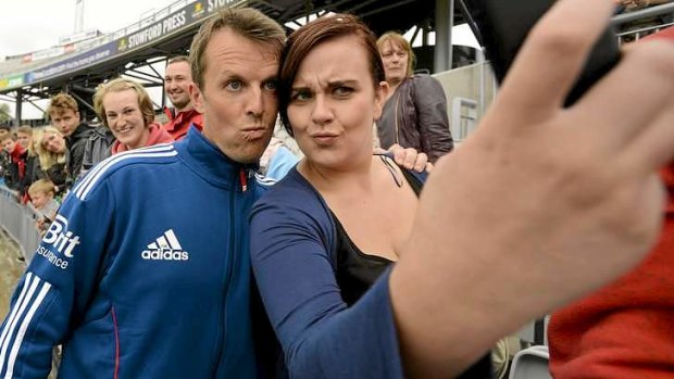 Graeme Swann poses for a photo with a fan.