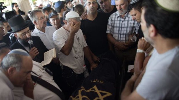 Relatives of the lone Israeli casualty mourn after he was killed by a mortar round. The Palestinian death toll has passed 200.