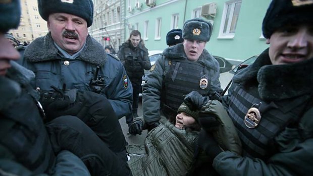 "Homosexual propoganda" ... police detain a gay rights activist during a protest near the State Duma in Moscow.