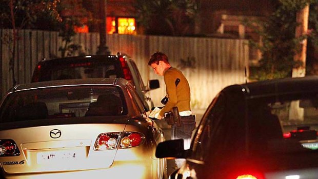 Senior Constable Katy Berger questions the driver of a car stopped  during the operation targeting gutter crawlers in the St Kilda area.