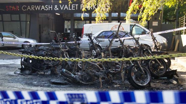 Burnt-out bikes ... Domino's Pizza scooters at the scene of the blaze near the Star car wash between Darlinghurst Road and Victoria Street yesterday morning.