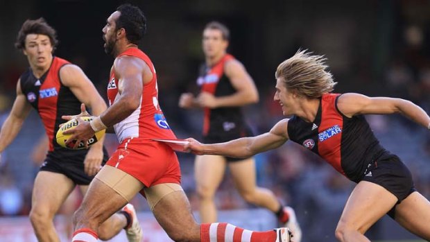 Stretched &#8230; a bootless Adam Goodes tries to wriggle free.