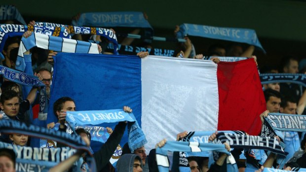 Flying the flag: Sydney FC fans raised the French tricolore in support of the victims of the Paris terrorist attacks.