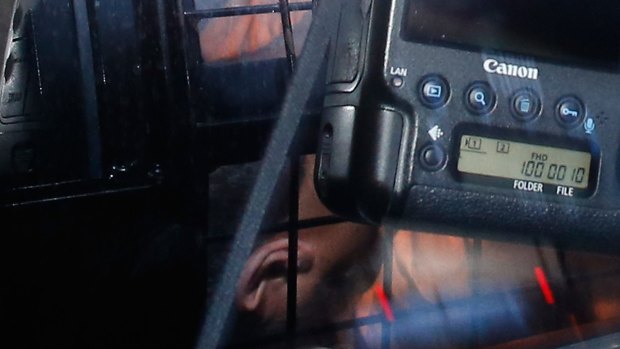 Omarjan Azari under police guard at Sydney's Central Local Court.