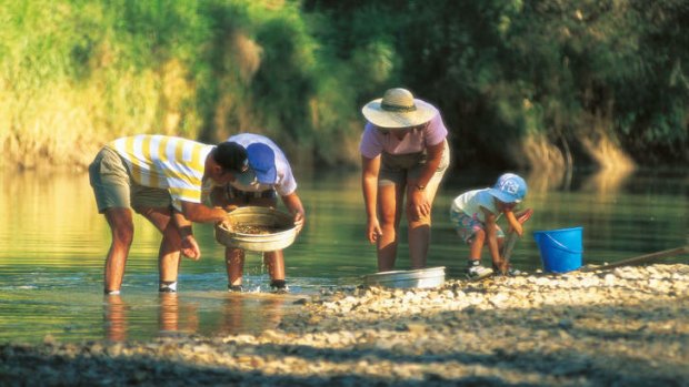 A family panning in the river at Rubyvale.