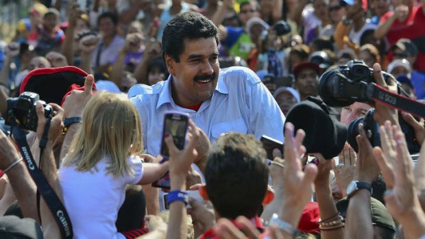 Accusation ... Nicolas Maduro greets supporters after casting his vote in Caracas.