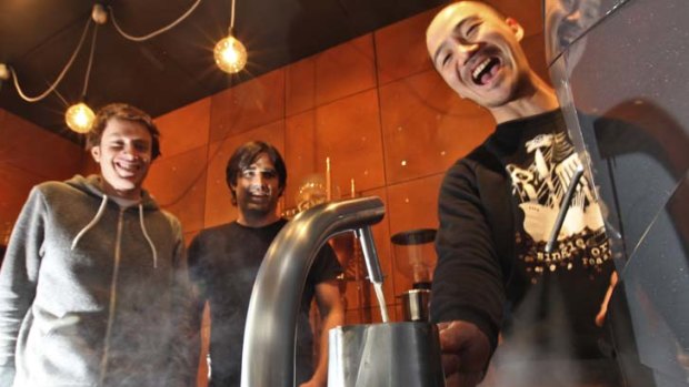 Pump it up ... Single Origin Roasters' designers, from left, Adam Preston and Ross Nicholls with barista Shoji Sasa at the Sideshow coffee bar in Surry Hills.
