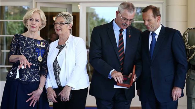 Doug and Kaye Baird are presented with a Victoria Cross for their late son by Governor-General Quentin Bryce with Prime Minister Tony Abbott at Government House on Tuesday.