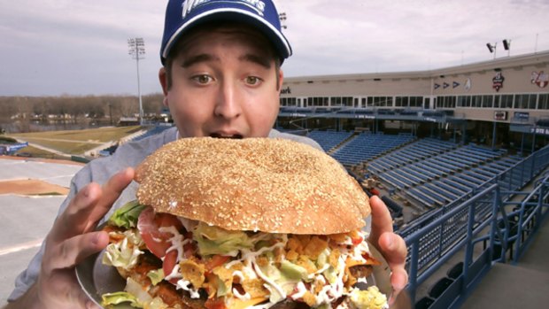 Hungry ... Josh Kowalczyk, an intern with the West Michigan Whitecaps, tries out the 4800 calorie burger.