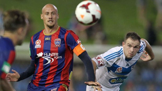 Jets veteran Ruben Zadkovich contests the ball with Melbourne's Leigh Broxham at Hunter Stadium.
