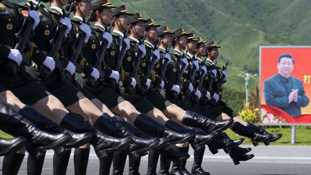 Chinese female troops practice marching near a portrait of Chinese President Xi Jinping in Beijing in September. 