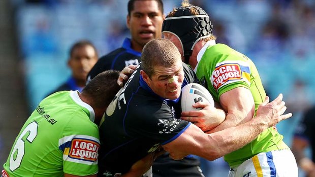 Retiring Bulldog Andrew Ryan takes the ball up in his last NRL game against Canberra.