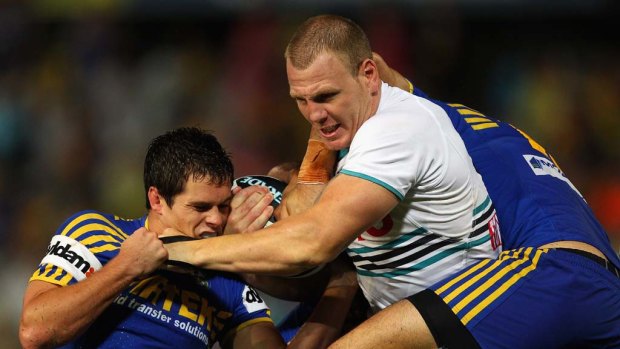 Swarm reception ... Penrith lock Luke Lewis wades into a pack of Parramatta players during his team's win at Parramatta Stadium on Friday night.