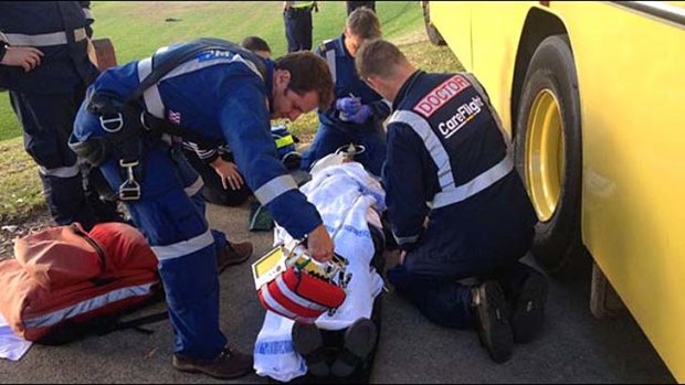 Paramedics tend to one of the victims on site after a runaway school bus struck three school girls.