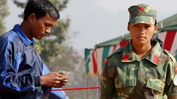 Starting a new life ... a former Nepalese Maoist child soldier examines his identity card  after being released.