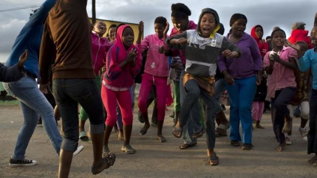 Celebration: Youngsters dance nearby the house of Nelson Mandela in Qunu where his coffin arrived on December 14.