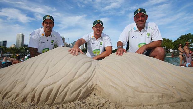 Ready to mo them down: (from left) Mitchell Johnson, David Warner and Darren Lehmann pose with a sand mo on Tuesday.