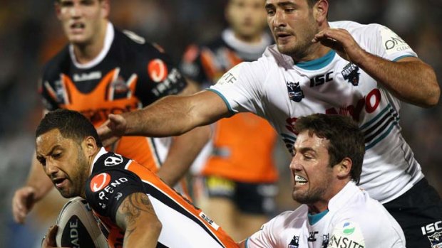 Magnificent Marshall ... Benji Marshall is tackled by Penrith's Trent Waterhouse, but the Wests Tigers five-eighth was still able to break the shackles to score.