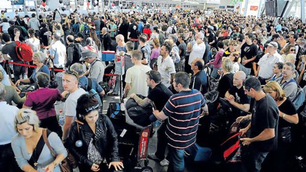 Hundreds of stranded travellers mill about at Sydney Airport.